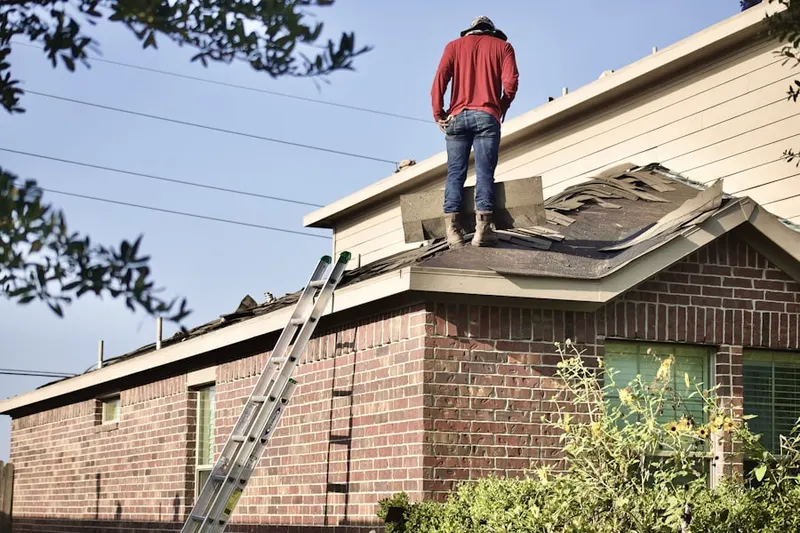 Professional roofer working on a residential roof in Mission Farms